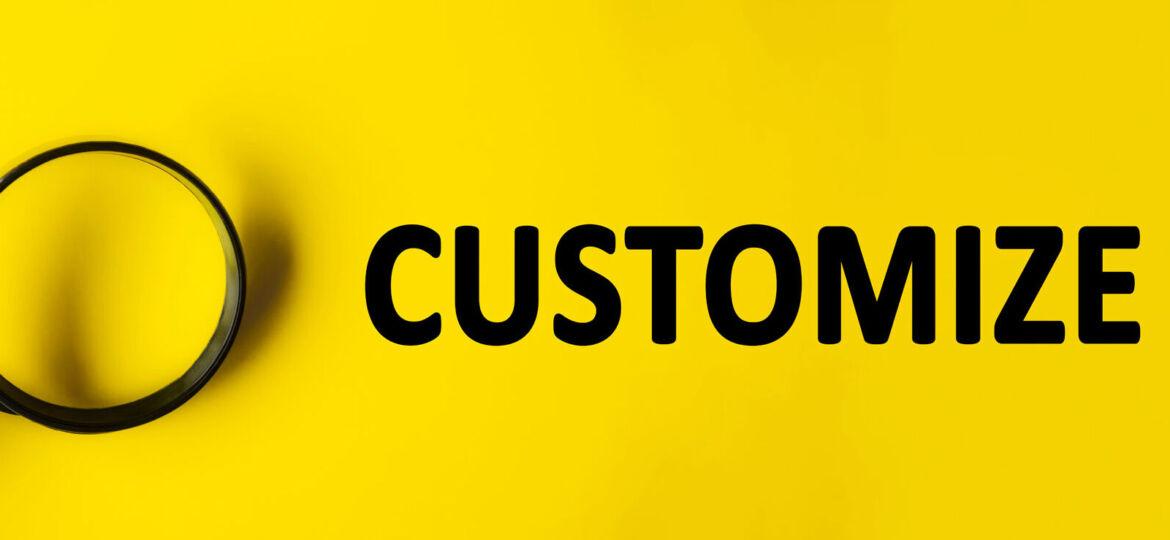 A magnifying glass on a bright yellow background focusing on the word 'CUSTOMIZE' in bold black letters, symbolizing the examination and personalization of a product or service.