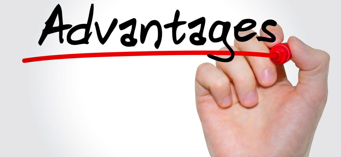A hand holding a red marker, underlining the word 'Advantages' written in black on a clear white background, symbolizing the emphasis on positive attributes or benefits.