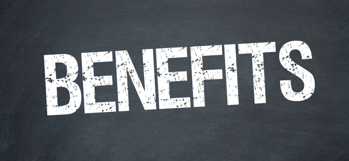 The word 'BENEFITS' in large, distressed white stencil-style font centered on a slate chalkboard background, conveying a strong message or heading related to advantages or positive aspects of a subject.
